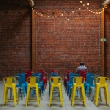 Brick wall with chairs in Ethics of Ownership